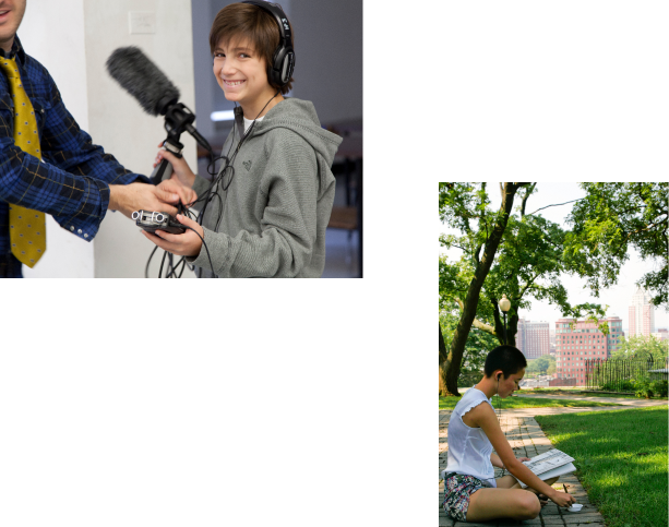 A teenage boy holding equipment in a filmmaking class. A teenage girl drawing outside in a city park.