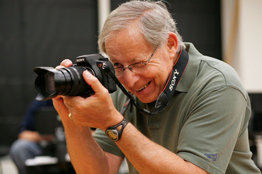 A man holding a digital camera.