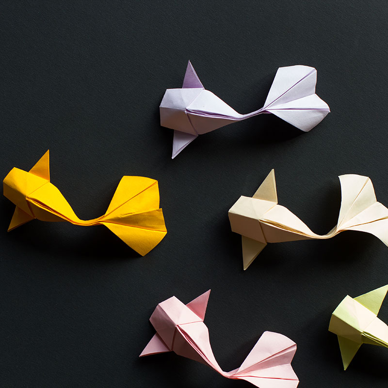 Origami shapes arranged against a black background.