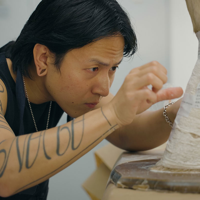 A man works on a sculpture project.