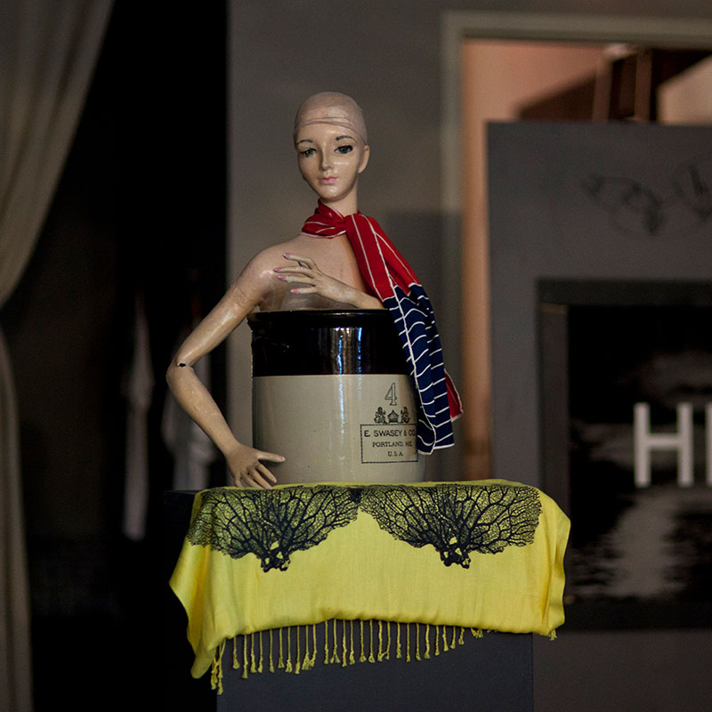 A crafted miniature of a woman wearing a scarf.