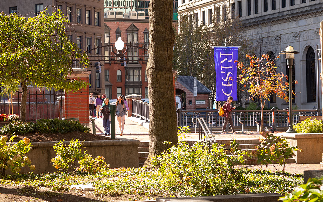 People walk across a pedestrian bridge adjacent to the RISD campus in Providence.