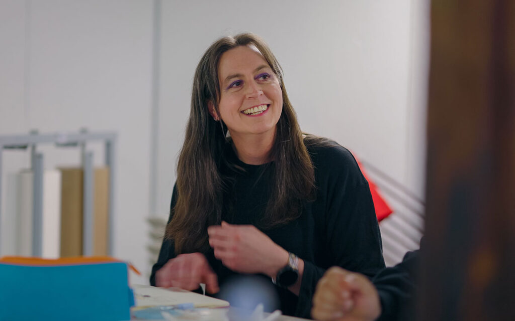 student in classroom smiling