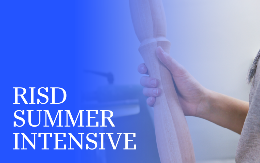 A person's hand holds a piece of wood.