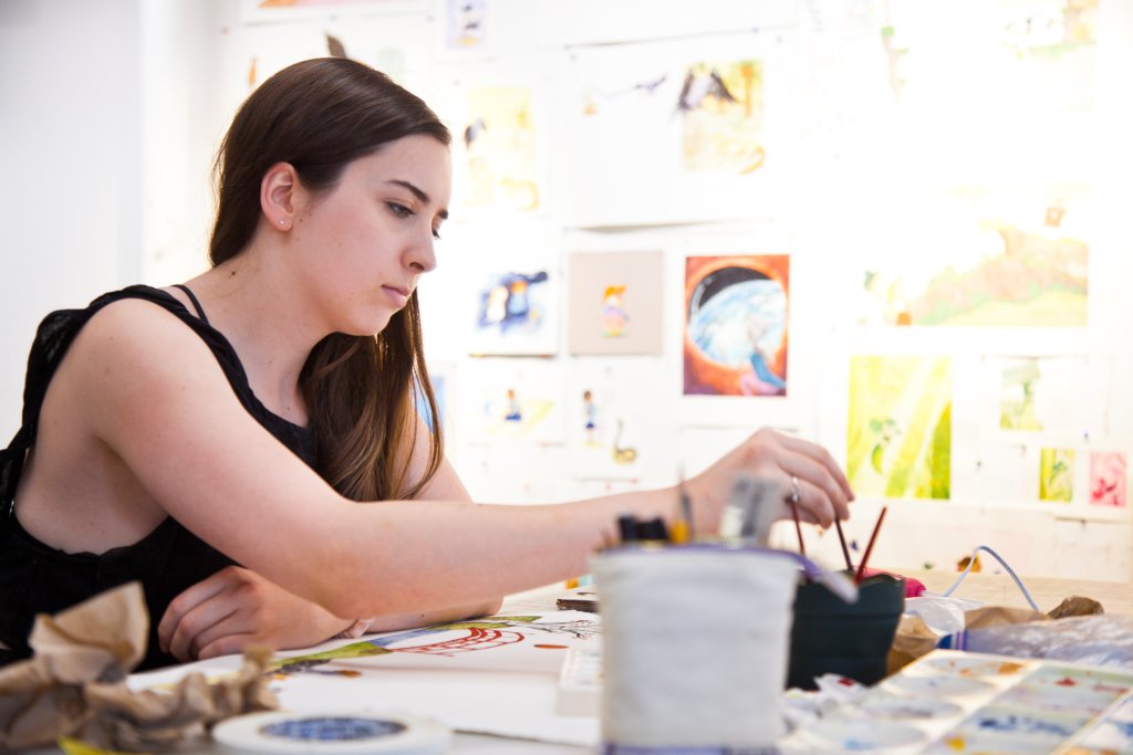 20190730 RISD CE 093_P1 person painting an illustration at a desk
